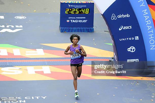 Tigist Tufa of Ethiopia crosses the finish line in 3rd place in the Pro Women's division at TAG Heuer Official Timekeeper and Timepiece of 2015 TCS...