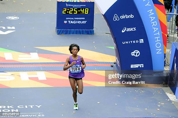 Tigist Tufa of Ethiopia crosses the finish line in 3rd place in the Pro Women's division at TAG Heuer Official Timekeeper and Timepiece of 2015 TCS...