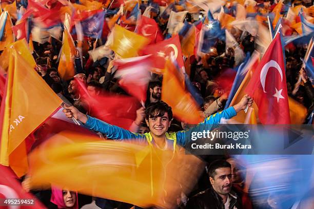 People wave flags outside the ruling AK Party headquarters on November 1 in Ankara, Turkey. Polls have opened in Turkey's second general election...