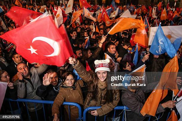 People wave flags outside the ruling AK Party headquarters on November 1 in Ankara, Turkey. Polls have opened in Turkey's second general election...