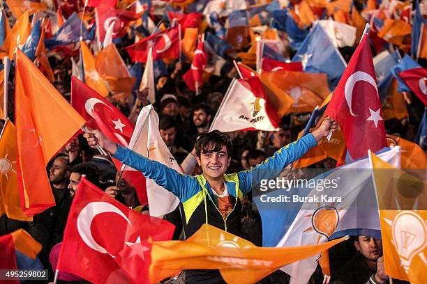 People wave flags outside the ruling AK Party headquarters on November 1 in Ankara, Turkey. Polls have opened in Turkey's second general election...