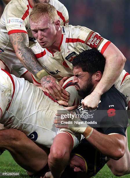 Chris Hill , and Liam Farrell of England tackle Jesse Bromwich of New Zealand during the International Rugby League Test Series match between England...