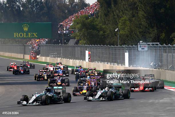 Nico Rosberg of Germany and Mercedes GP leads Lewis Hamilton of Great Britain and Mercedes GP, Daniil Kvyat of Russia and Infiniti Red Bull Racing,...