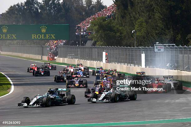 Nico Rosberg of Germany and Mercedes GP leads Lewis Hamilton of Great Britain and Mercedes GP, Daniil Kvyat of Russia and Infiniti Red Bull Racing,...