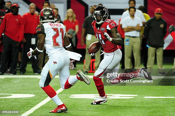 Julio Jones of the Atlanta Falcons runs past Alterraun Verner of the Tampa Bay Buccaneers after a catch during the first half at the Georgia Dome on...
