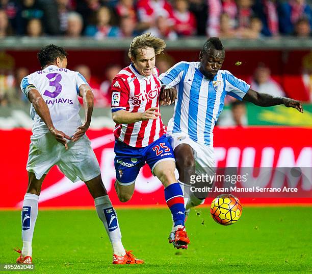 Halilovic of Real Sporting de Gijon duels for the ball with Weligton and Arthur Boka of Malaga CF during the La Liga match between Real Sporting de...