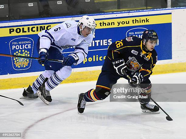 Andrew Mangiapane of the Barrie Colts gets past Stephen Gibson of the Mississauga Steelheads during OHL game action on November 1, 2015 at the...