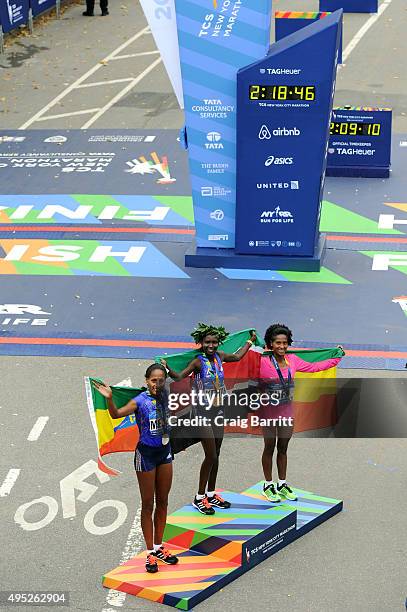 Women's winner Mary Keitany of Kenya poses alongside second place Aselefech Mergia of Ethiopia and third place Tigist Tufa of Ethiopia during the...