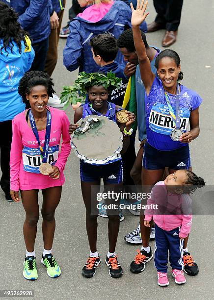 Mary Keitany of Kenya poses alongside second place Aselefech Mergia of Ethiopia and third place Tigist Tufa of Ethiopia after the trophy presentation...