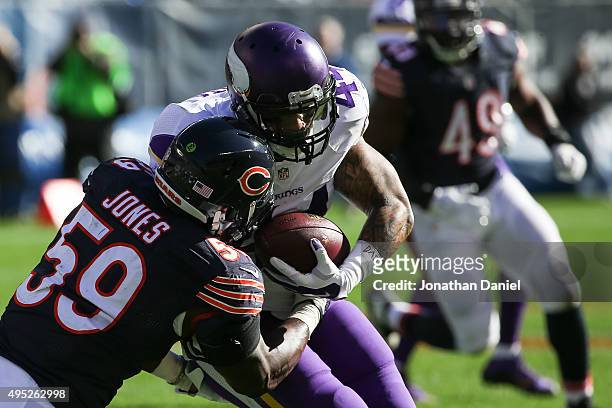 Matt Asiata of the Minnesota Vikings carries the football against Christian Jones of the Chicago Bears in the second quarter at Soldier Field on...