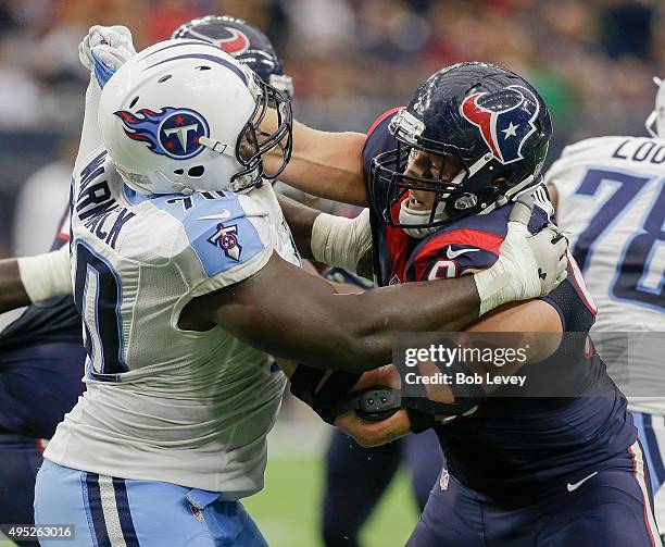 Chance Warmack of the Tennessee Titans and J.J. Watt of the Houston Texans lockup at the line at Reliant Park on November 1, 2015 in Houston, Texas.