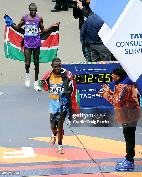 Filmmaker and Grand Marshal of the New York City Marathon Spike Lee congratulates Men's winner Stanley Biwott of Kenya and second place Geoffrey...