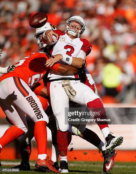 Carson Palmer of the Arizona Cardinals is hit while throwing a second quarter pass by Armonty Bryant of the Cleveland Browns at FirstEnergy Stadium...