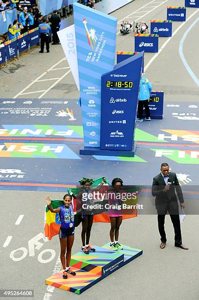 Women's winner Mary Keitany of Kenya poses alongside second place Aselefech Mergia of Ethiopia and third place Tigist Tufa of Ethiopia during the...