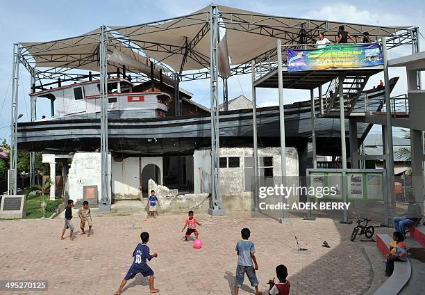 Indonesia-quake-tsunami-Aceh-schools" BY ARLINA ARSHAD This picture taken in Banda Aceh on April 4, 2012 shows children are playing football next to...