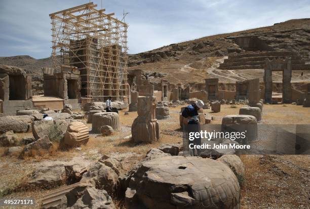 Groundskeepers work amidst the ancient Persepolis archeological site on May 30, 2014 in Persepolis, Iran. The ruins mark the site of the 6th century...