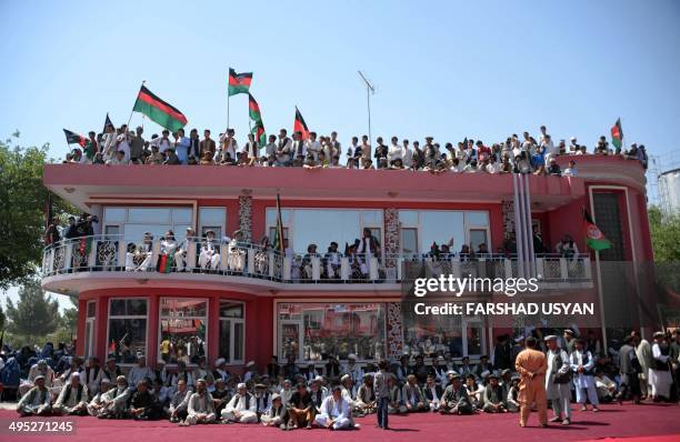Supporters of Afghan presidential candidate Ashraf Ghani listen as he speaks during an election campaign rally in Shibarghan, the capital of Jawzjan...