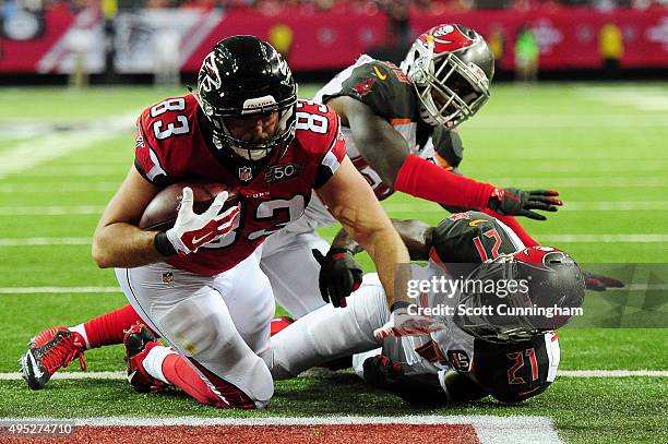 Jacob Tamme of the Atlanta Falcons scores a touchdown over Alterraun Verner of the Tampa Bay Buccaneers during the second half at the Georgia Dome on...