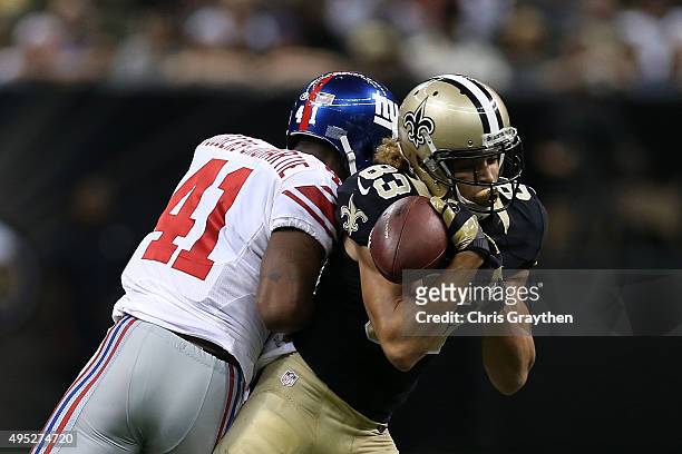Willie Snead of the New Orleans Saints is hit by Dominique Rodgers-Cromartie of the New York Giants and looses the ball during the fourth quarter of...