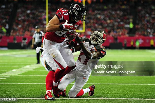 Jacob Tamme of the Atlanta Falcons scores a touchdown over Alterraun Verner of the Tampa Bay Buccaneers during the second half at the Georgia Dome on...