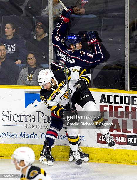 Tommy Cross of the Providence Bruins checks Henrik Samuelsson of the Springfield Falcons during an American Hockey League game at the Dunkin' Donuts...