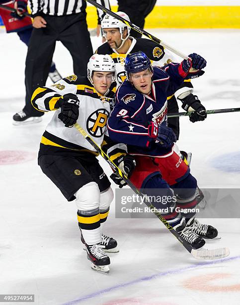 Frank Vatrano of the Providence Bruins checks Henrik Samuelsson of the Springfield Falcons during an American Hockey League game at the Dunkin'...