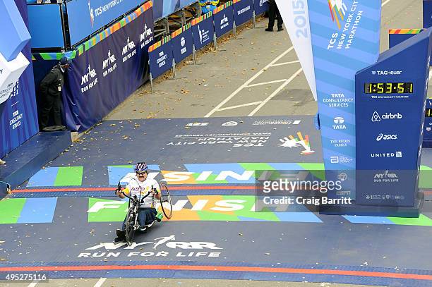 An athlete in the Wheelchair division crosses the finish line at TAG Heuer Official Timekeeper and Timepiece of 2015 TCS New York City Marathon on...