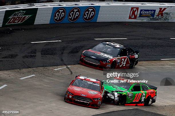 Danica Patrick, driver of the GoDaddy Chevrolet, makes contact with David Gilliland, driver of the Jerry Cook Hall of Fame Tribute Ford, during the...