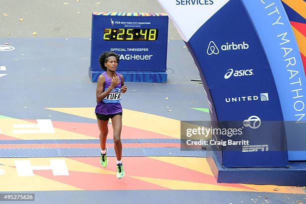 Tigist Tufa of Ethiopia crosses the finish line in 3rd place in the Pro Women's division at TAG Heuer Official Timekeeper and Timepiece of 2015 TCS...