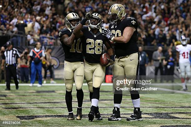 Spiller of the New Orleans Saints celebrates a touchdown with teammates following a late touchdown against the New York Giants at the Mercedes-Benz...