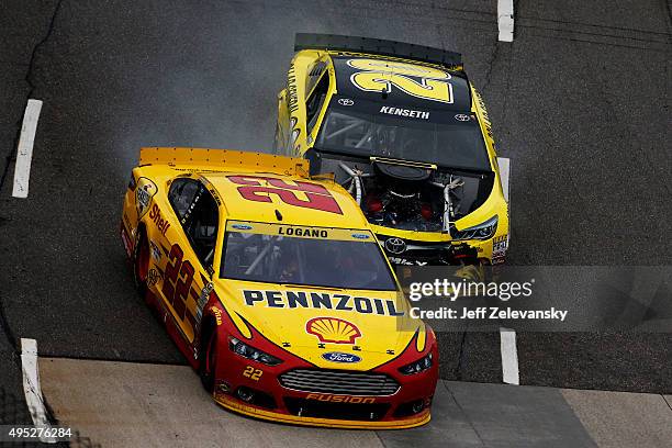 Matt Kenseth, driver of the Dollar General Toyota, makes contact with Joey Logano, driver of the Shell Pennzoil Ford, during the NASCAR Sprint Cup...