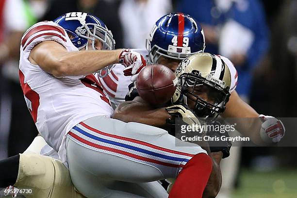 Marcus Murphy of the New Orleans Saints has the ball stripped by New York Giants defensive back Craig Dahl at Mercedes-Benz Superdome on November 1,...