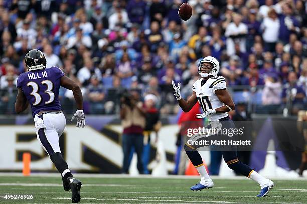 Wide receiver Malcom Floyd of the San Diego Chargers scores a third quarter touchdown past strong safety Will Hill of the Baltimore Ravens during a...