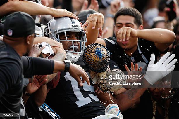 Michael Crabtree of the Oakland Raiders celebrates with fans after a 36-yard touchdown against the New York Jets during their NFL game at O.co...
