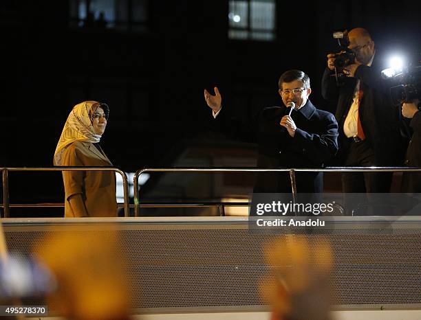 Turkish Prime Minister Ahmet Davutoglu and his wife Sare Davutoglu address to supporters on a bus as he goes to the Turkey's Justice and Development...