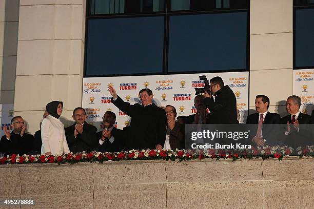 Turkish Prime Minister Ahmet Davutoglu waves to supporters from the balcony of the AKP Party headquarters after his party won a critical election...