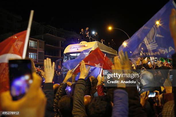 Turkish Prime Minister Ahmet Davutoglu addresses to supporters on a bus as he goes to the Turkey's Justice and Development Party's headquarters after...