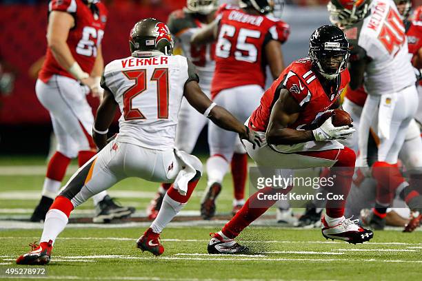 Julio Jones of the Atlanta Falcons runs past Alterraun Verner of the Tampa Bay Buccaneers after a catch during the second half at the Georgia Dome on...