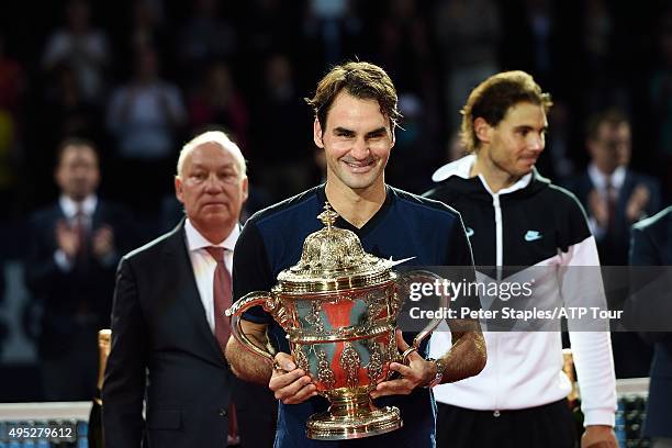 Roger Federer of Switzerland with the championship trophy with runner-up Rafael Nadal of Spain at the Swiss Indoors Basel at St. Jakobshalle on...