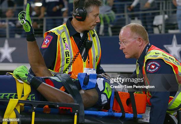 Ricardo Lockette of the Seattle Seahawks waves to fans while being carted off the field in the second quarter at AT&T Stadium on November 1, 2015 in...