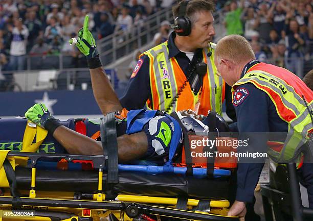 Ricardo Lockette of the Seattle Seahawks waves to fans while being carted off the field in the second quarter at AT&T Stadium on November 1, 2015 in...