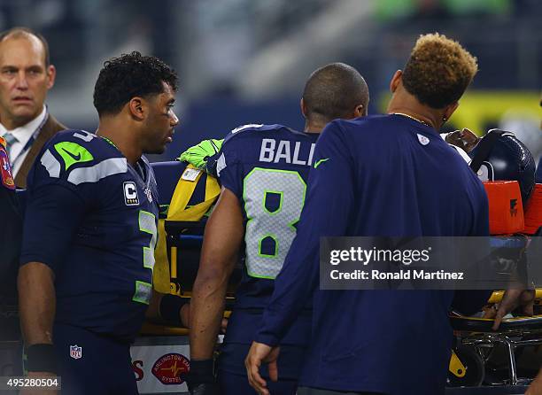 Russell Wilson of the Seattle Seahawks checks on Ricardo Lockette of the Seattle Seahawks after an injury in the second quarter against the Dallas...