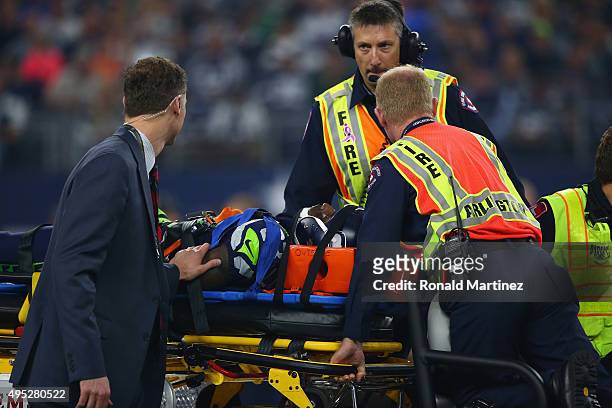 Ricardo Lockette of the Seattle Seahawks is taken off the field after an injury in the second quarter against the Dallas Cowboys at AT&T Stadium on...