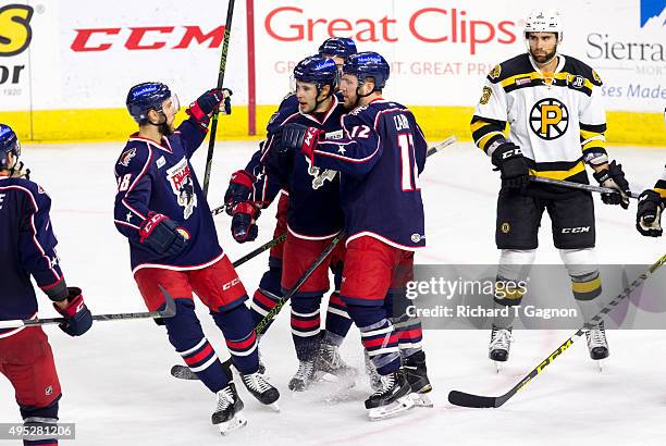 Craig Cunningham of the Springfield Falcons celebrates his goal with teammates Greg Carey, Dustin Jeffrey and Justin Hache during an American Hockey...