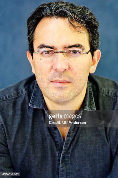 Colombian writer Juan Gabriel Vasquez, poses during a portrait session held on May 18, 2014 in Nantes, France.