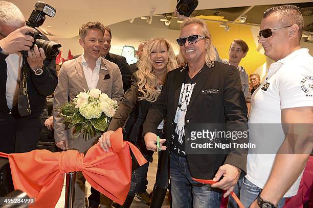 Robert And Carmen Geiss pose during the opening event of a new Titan Shop on June 2, 2014 in Osnabruck, Germany.