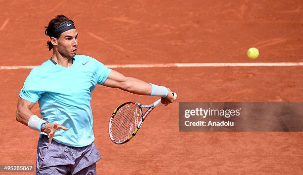 Rafael Nadal of Spain returns the ball to Dusan Lajovic of Serbia during their fourth round match of the French Open tennis tournament at Roland...