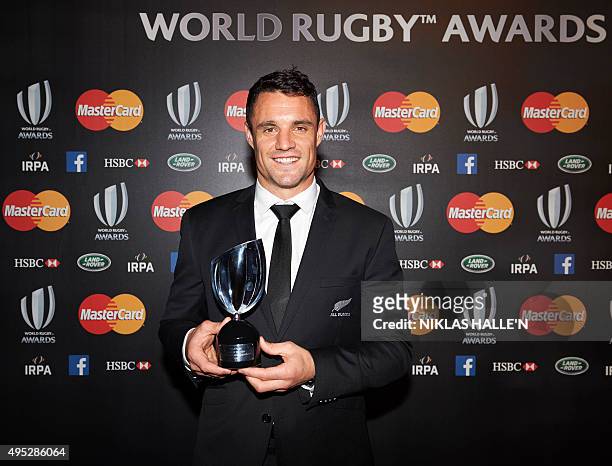 New Zealand Rugby Union player Daniel Carter poses for photographers winning the Player of the Year Award at the World Rugby Awards in London on...