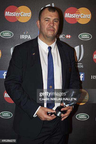 Australian head coach Michael Cheika poses for photographers after winning the Coach of the Year Award at the World Rugby Awards in London on...