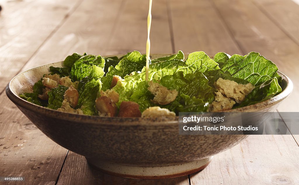 Caesar Salad with Dressing Pour